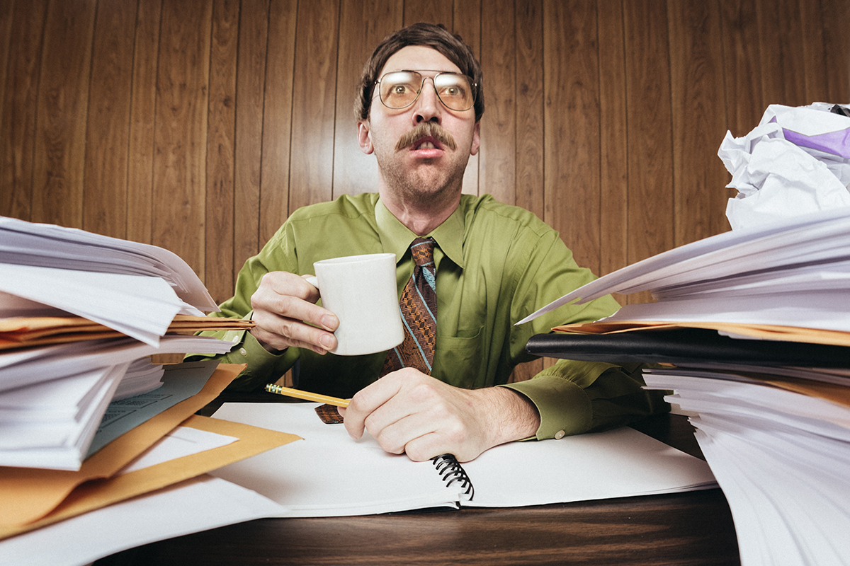 Man at messy desk with coffee