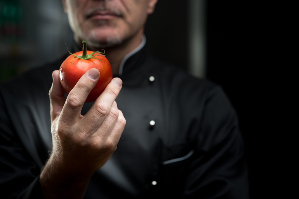 Chef observing a tomato